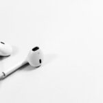 Apple AirPods on white surface