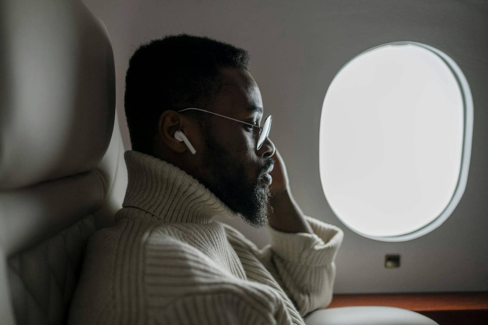 An Airplane Passenger Sitting on Window Seat