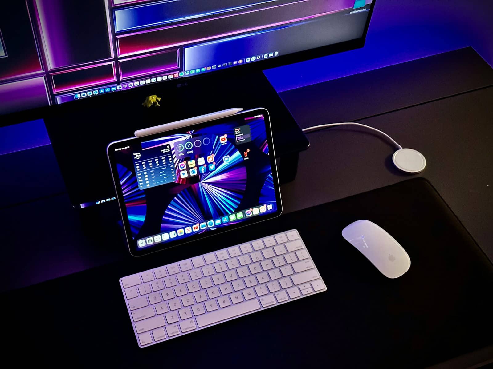 a tablet computer sitting on top of a desk next to a keyboard