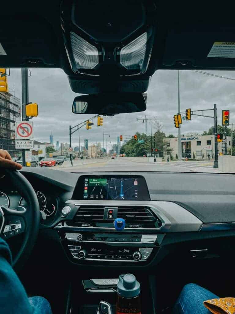 a person driving a car on a city street