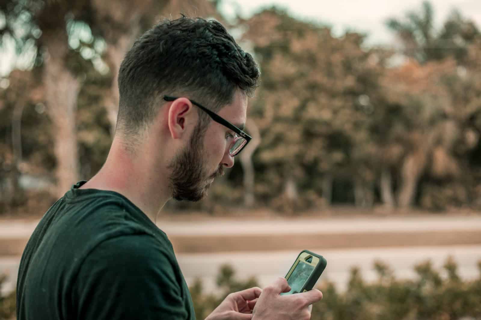 man looking down on his phone