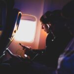 photo of three people listening to music inside airplane