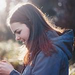 woman holding phone smiling