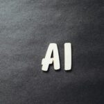 the word ai spelled in white letters on a black surface