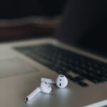 white earbuds on macbook pro