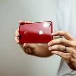 person holding red iphone 7 plus